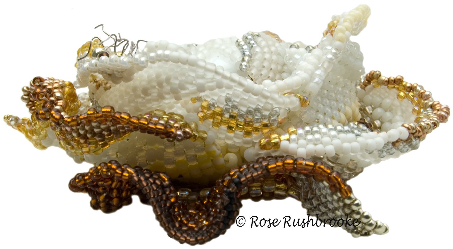 Side view of rose from Covid 19 - White Rose. Bead Embroidered using a variety of glass beads, crystals, pearls, and cabochons. Image copyright © Rose Rushbrooke.