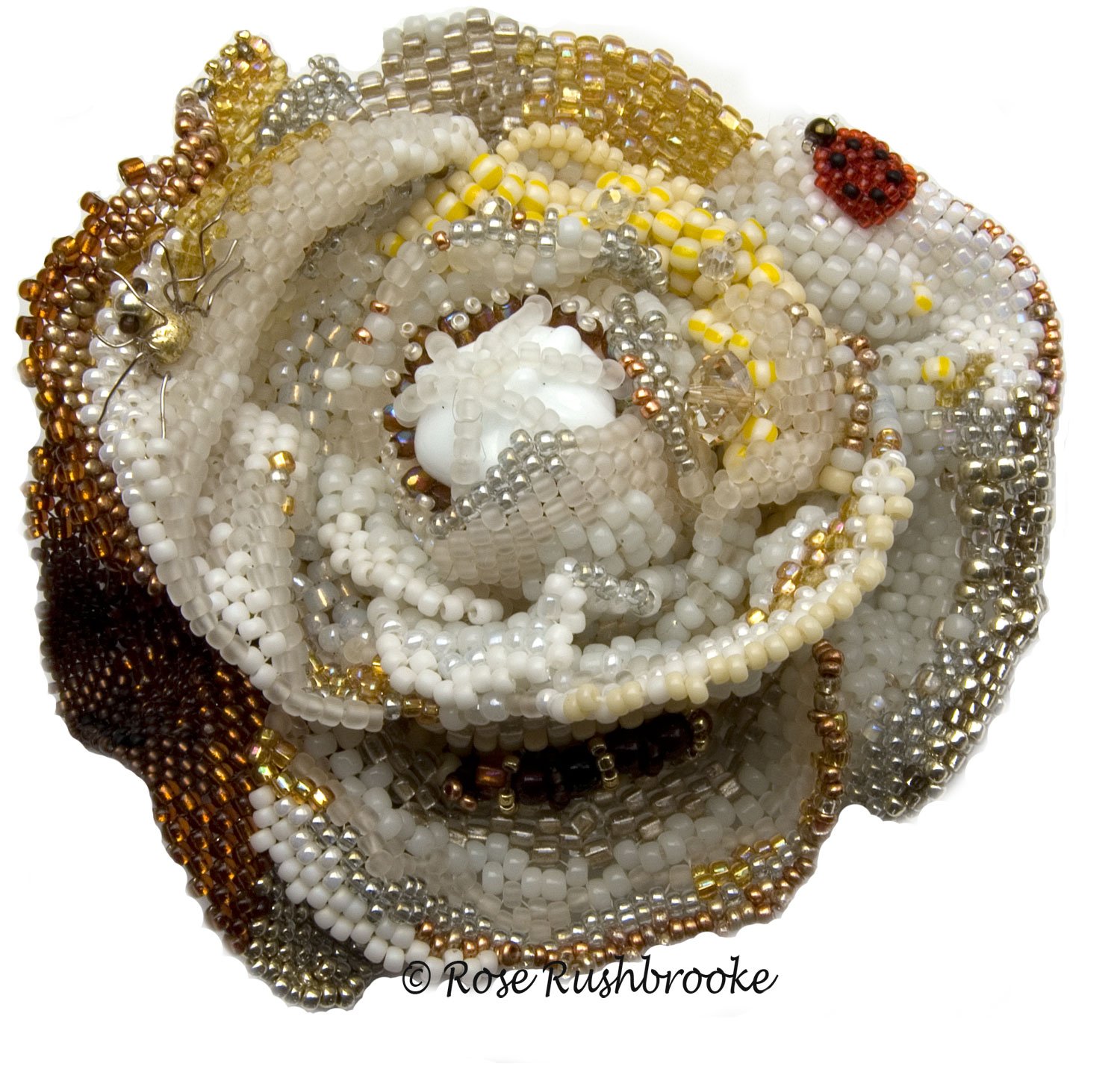 Top view of rose from Covid 19 - White Rose. Bead Embroidered using a variety of glass beads, crystals, pearls, and cabochons. Image copyright © Rose Rushbrooke.