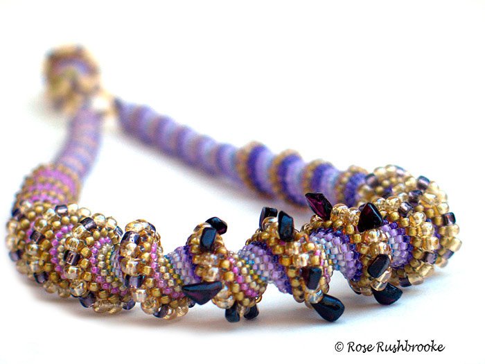 Royal Crustacean Cellini spiral necklace by Rose C Rushbrooke. Bead weaving with glass seed beads and garnet chips. Image copyright &copy; Rose C Rushbrooke.