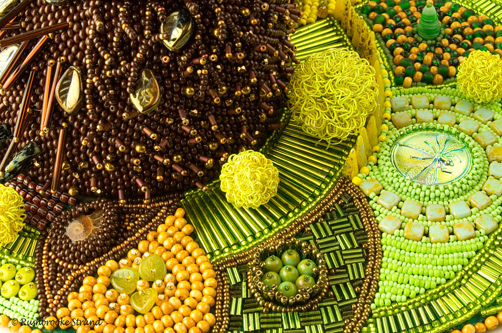 Close up 3 of Triffid - seed beads, crystals, Czech glass beads, ceramic focal, ammonites, and selected beads. Peyote stitch beadweaving, bead embroidery. BeadDreams 2018 finalist. Image copyright &copy; Rose Rushbrooke.