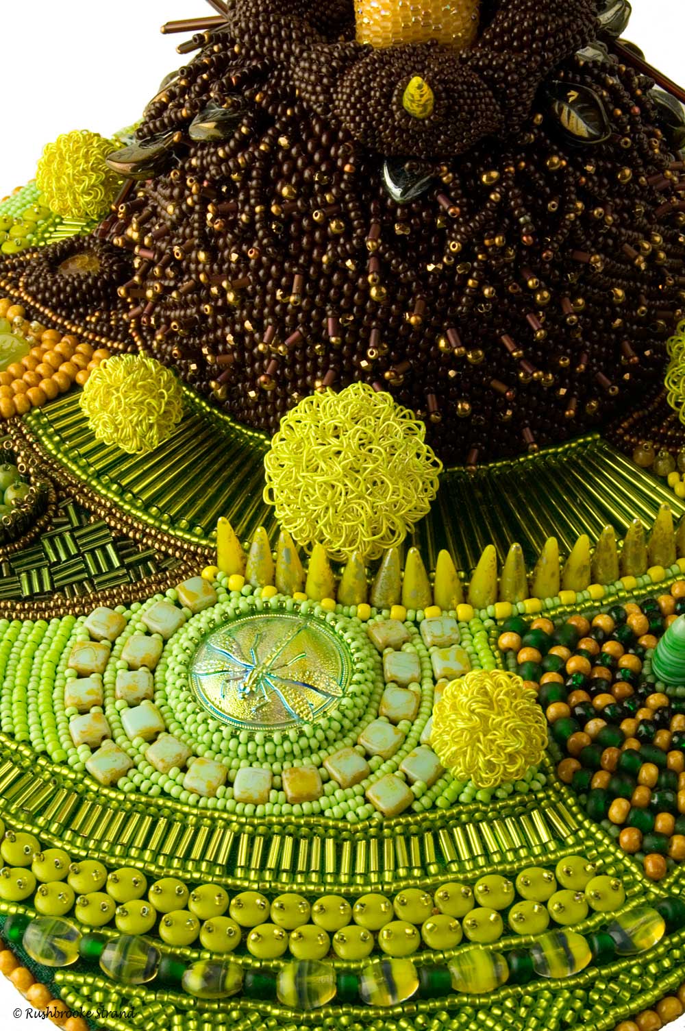 Close up 2 of Triffid - seed beads, crystals, Czech glass beads, ceramic focal, ammonites, and selected beads. Peyote stitch beadweaving, bead embroidery. BeadDreams 2018 finalist. Image copyright &copy; Rose Rushbrooke.