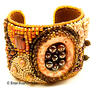 Bead embroidered cuff. Glass seed beads, cabochons, ceramic focal cuff. Image copyright © Rose Rushbrooke.