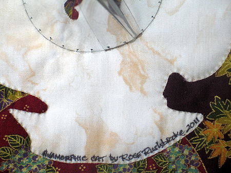 Detail 2 of Anamorphic Cat - catoptric perspective, conical mirror quilt. Image copyright &copy; Rose Rushbrooke.