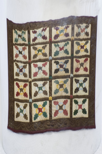 Detail 1 of Anamorphic Oakleaf and Reel - catoptric perspective, cylindrical mirror quilt. Image copyright &copy; Rose Rushbrooke.