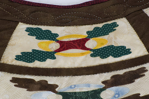 Detail 3 of Anamorphic Oakleaf and Reel - catoptric perspective, cylindrical mirror quilt. Image copyright &copy; Rose Rushbrooke.