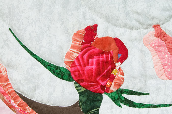 Close up of hand stitched rose and leaves. Image copyright &copy; Rose Rushbrooke.