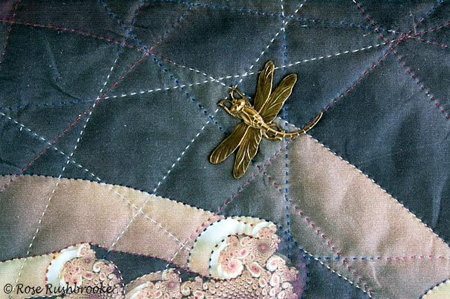 Close up of a dragonfly stitched onto fabric using peyote stitch and seed beads. Image copyright &copy; Rose Rushbrooke.